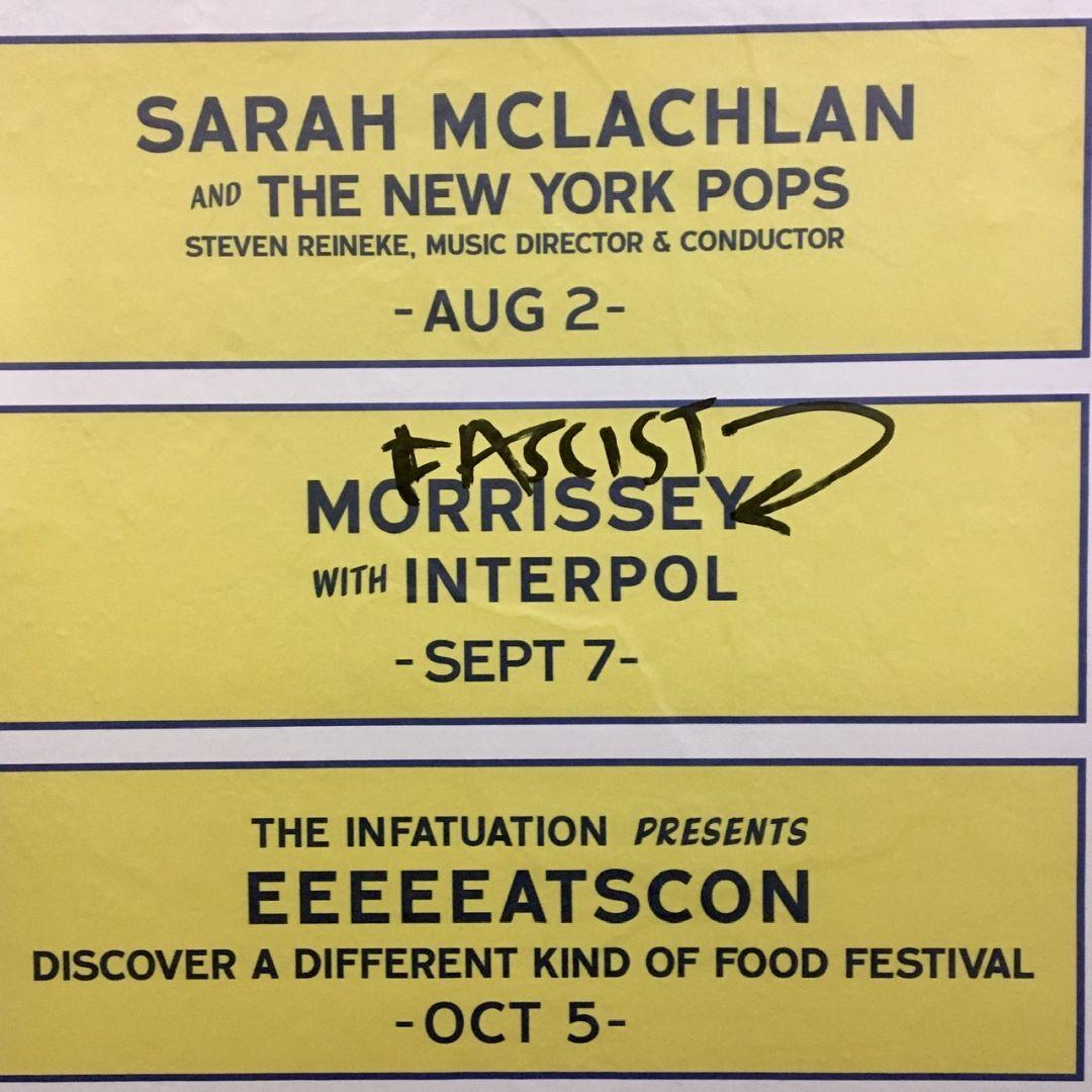 A subway billboard announces Morrissey with Interpol. A marker scribbles reads “Fascist” with an arrow pointing at Morrisey.