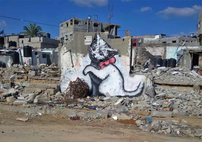 Banksy street art of cat (kitten) playing outside in Gaza, Palestine