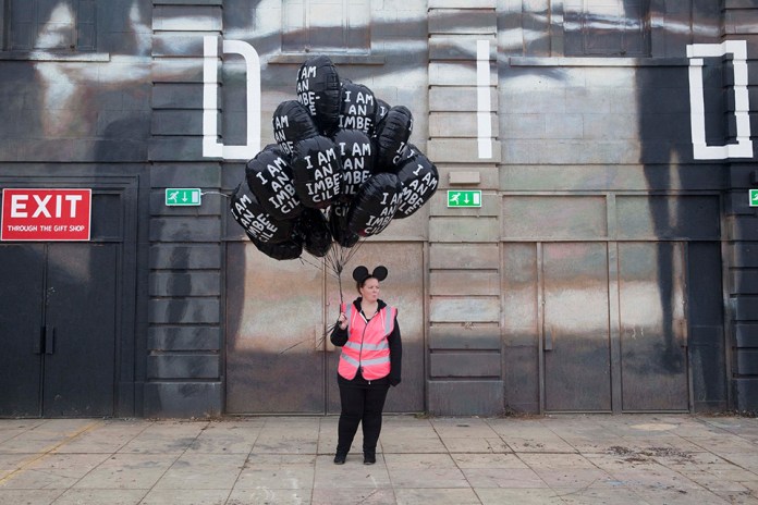 Image from Banksy's Dismaland with mouse girl selling balloons with the text "I am an imbecille"