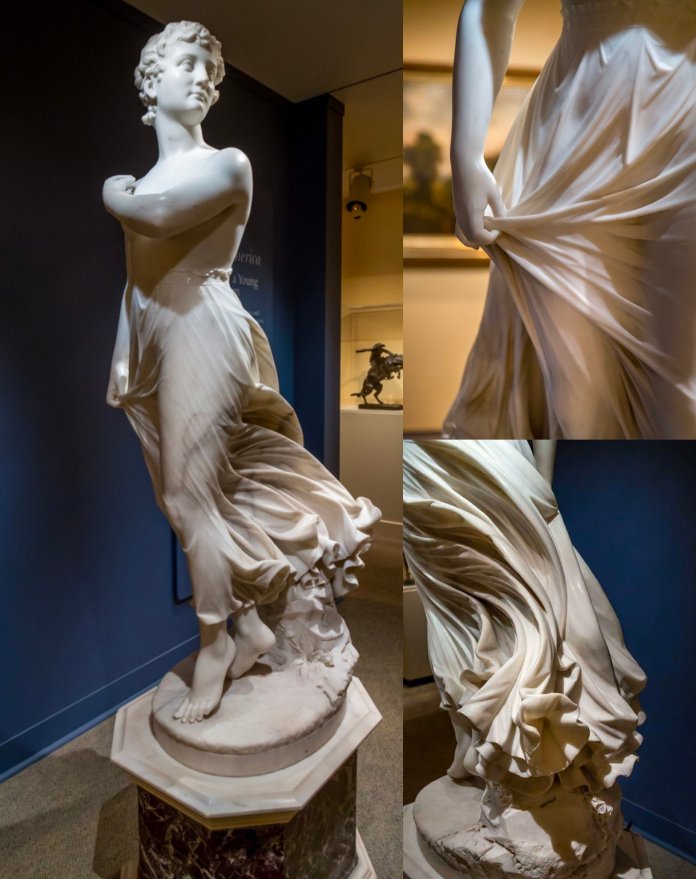 "The West Wind," a stunning marble sculpture by American artist Thomas Ridgeway Gould, inspired by Percy Shelley’s poem “Ode to the West Wind.” The statue depicts a young woman with flowing garments, skillfully carved to create a lifelike sense of movement. Her dress clings and swirls around her form, each fold and ripple of fabric intricately detailed, as though caught in a powerful breeze. Her arms are crossed, her gaze distant and thoughtful, embodying the spirit of change and revolution symbolized by the west wind. The close-up views emphasize the delicacy and precision of Gould's marble craftsmanship, capturing both motion and emotion.