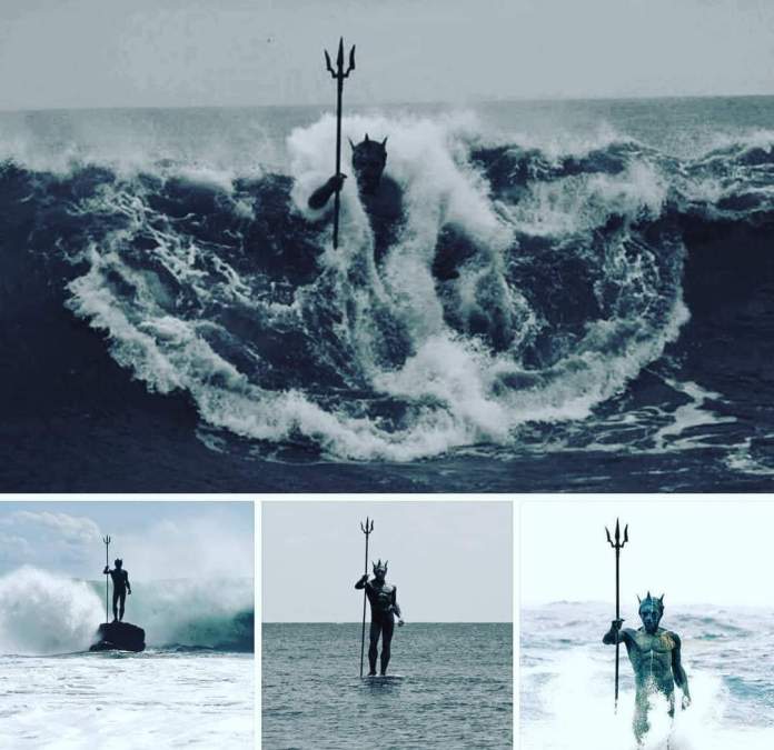 A collage of four images showcasing the Neptune (Poseidon) statue in Gran Canaria, Spain. The top image features a dramatic black-and-white shot of the statue rising amidst a massive wave, creating a powerful visual impact. The bottom-left image captures Neptune standing on a rock as a wave breaks behind him. The bottom-middle image shows the statue standing serenely in calm waters, highlighting its connection to the ocean. The bottom-right image is a closer shot of Neptune surrounded by crashing waves, emphasizing the intricate details of the sculpture and its interaction with the sea.