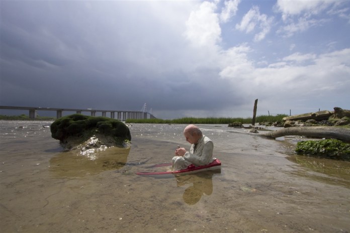 Slowly sinking. St Nazaire, France. Cement Eclipses -By Isaac Cordal 2013 in 17