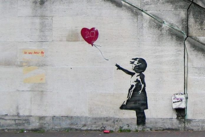 Banksy street art mural of a girl with a balloon.