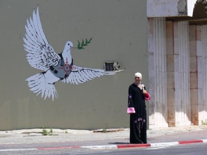 The Banksy Dove by Banksy in at the West Bank in Palestine