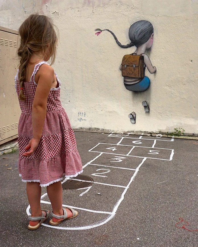 A young girl in a red checkered dress stands on a hopscotch grid, hesitating as she looks at a mural by Seth Globepainter. The mural, titled "Viviane Hesitates," located in La Butte aux Cailles, Paris, France, depicts a child with a backpack, mid-leap, blending seamlessly with the wall. The scene combines playful innocence with urban artistry, inviting viewers to step into the imagination of childhood.