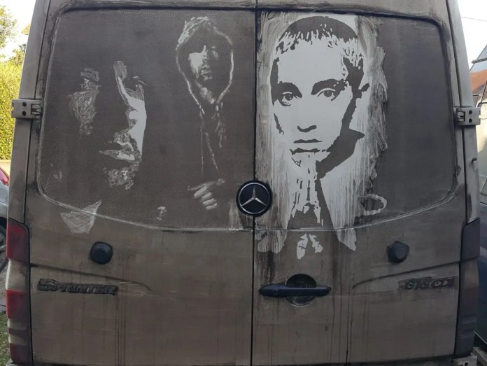 Grime art on the back of a Mercedes Sprinter van featuring detailed portraits of the artist Eminem, etched into the dirt on the vehicle’s surface. The artwork includes three depictions of Eminem: a close-up of his face, a hooded figure, and a third portrait with a solemn expression. The skillful use of light and shadow transforms the van's dirty exterior into a striking tribute to the rapper.