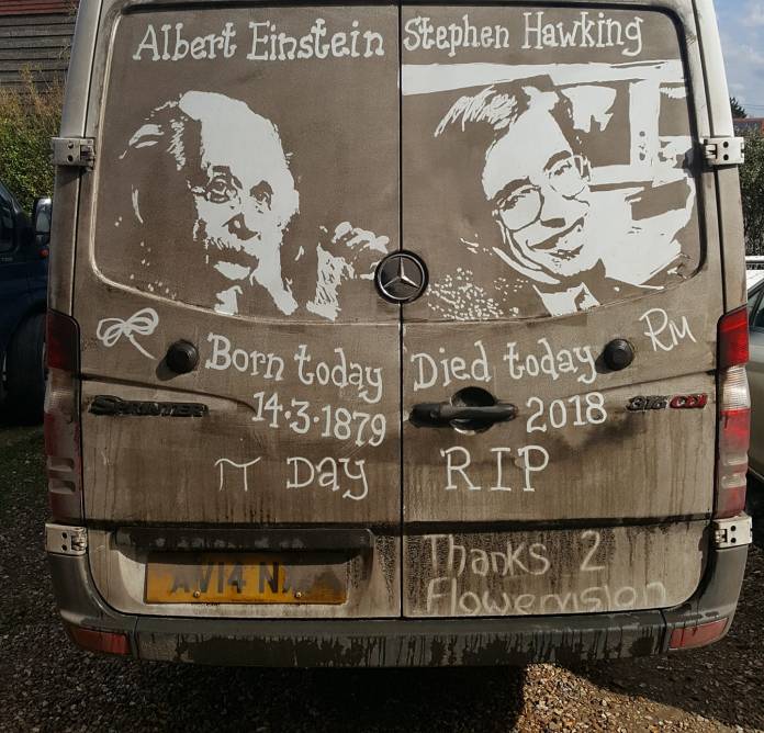 Grime art on the back of a Mercedes Sprinter van featuring portraits of Albert Einstein and Stephen Hawking, along with handwritten text honoring both scientists. The artwork includes the phrases 'Born today 14-3-1879' under Einstein and 'Died today 2018 RIP' under Hawking, with additional notes like 'π Day' and 'Thanks 2 Flowervision.' The artist has skillfully used the van’s dirt to create a commemorative tribute to these influential figures in science.