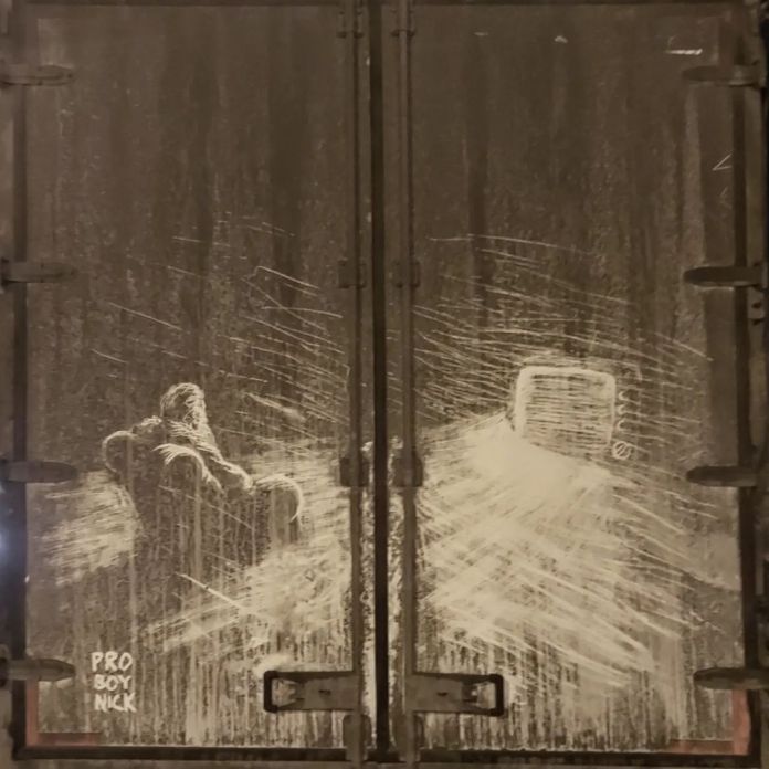 Detailed grime art by ProBoyNick on the back doors of a truck, depicting a person sitting in contemplation, facing a distant television screen. The strokes and shading create an intense scene that speaks to isolation and despair, reflecting the artist's anti-war sentiment regarding the war in Ukraine.