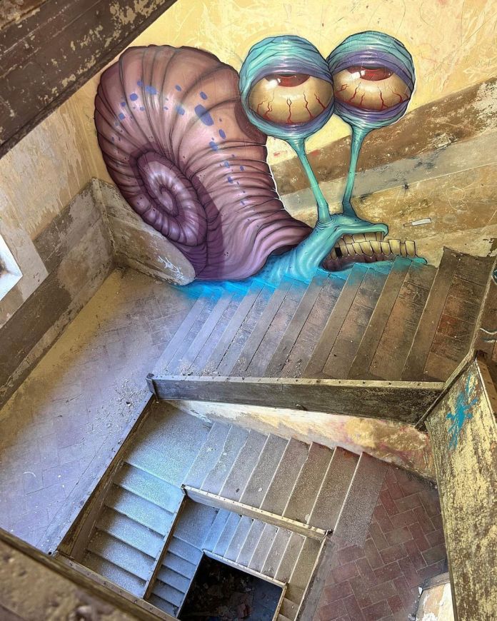 Post-graffiti artwork by DavidL featuring a large, surreal snail with tired, bloodshot eyes, painted on the walls of a distressed stairwell, located outside Barcelona, Spain.
