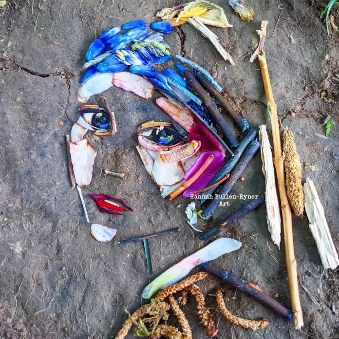 An ephemeral natural art piece by Hannah Bullen-Ryner, inspired by Johannes Vermeer’s ‘Girl with a Pearl Earring.’ This piece, arranged directly on the ground, recreates the famous painting using organic materials such as vibrant blue petals for the headscarf, yellow and green plant elements for highlights, and twigs and dried leaves for facial features. The use of red petals adds a touch of color to the lips, while the soft, earthy texture of the background complements the organic materials, capturing the essence of Vermeer’s classic portrait in a fleeting, nature-based medium.