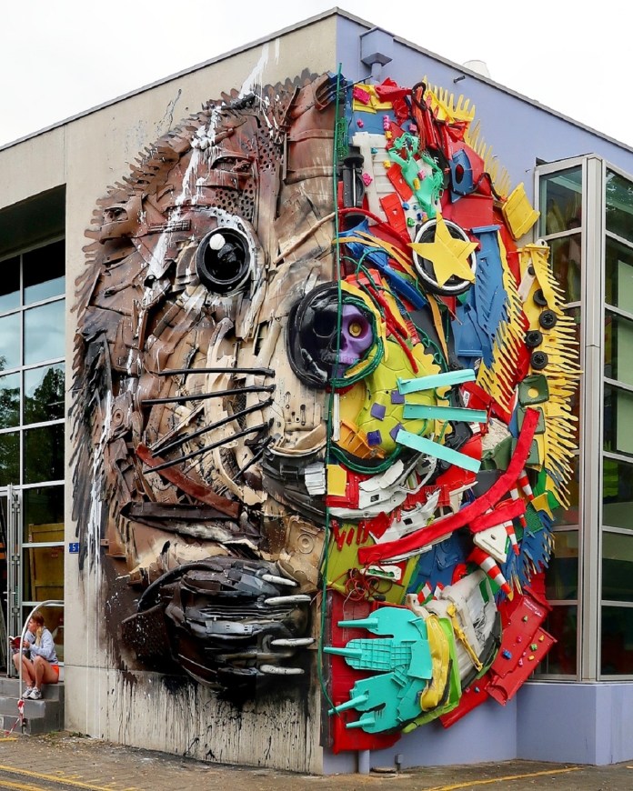 Beaver sculpture on the corner of a building in Geneva, Switzerland, made from trash and plastic—left side brown and realistic, right side colorful and chaotic.