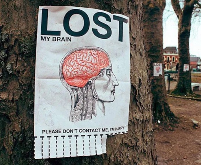 Poster on a tree shows a side-profile brain diagram and the headline “LOST: My Brain,” with the message “Please don’t contact me, I’m happy” and tear-off tabs.