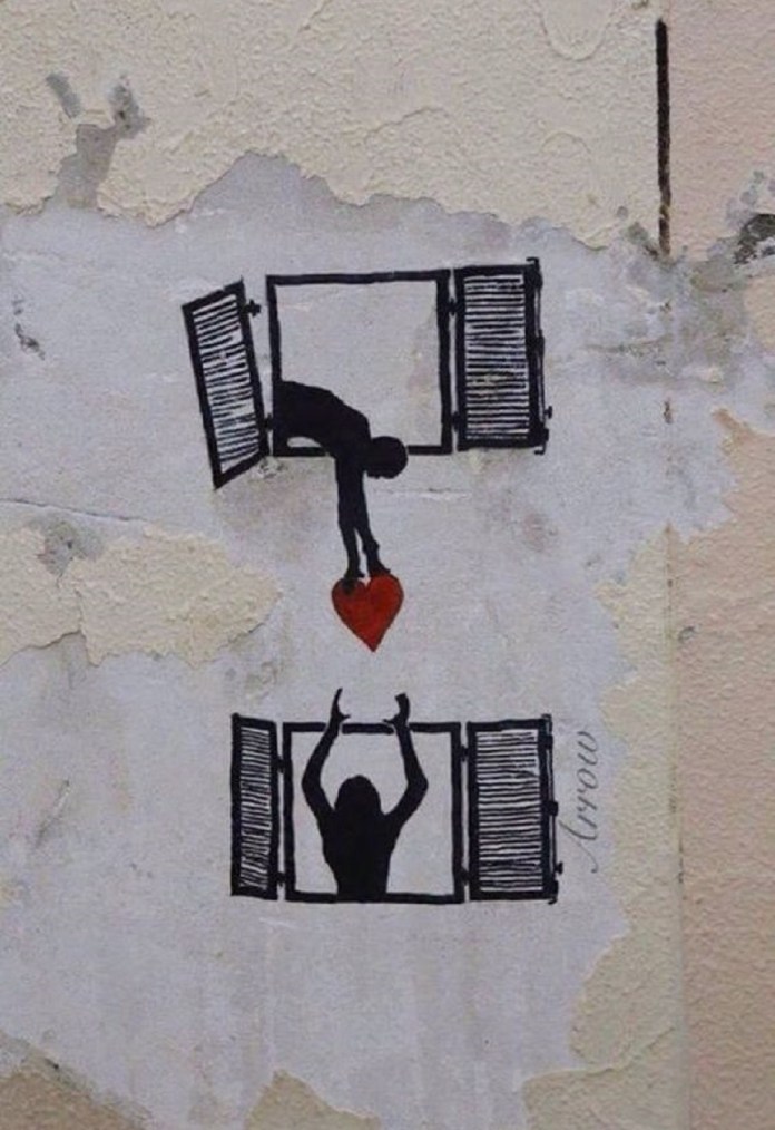 Two black silhouettes at painted window frames, with one figure reaching down to give a red heart to another figure below.