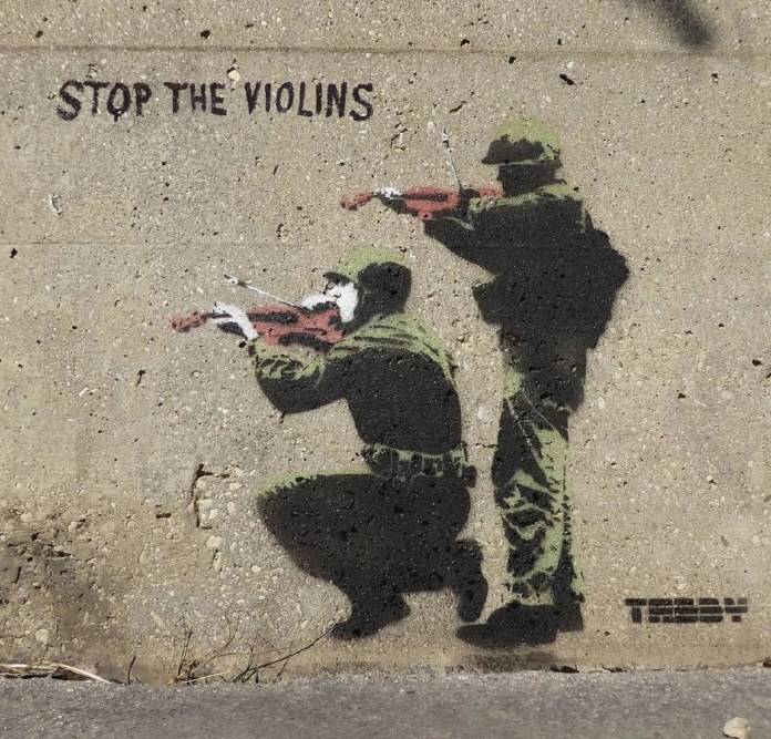 Stencil artwork depicting soldiers aiming violins instead of weapons, with the phrase "Stop the Violins."