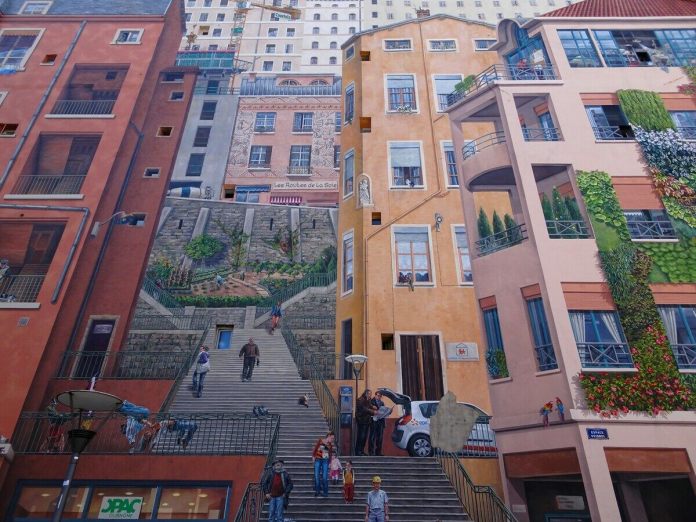 A detailed section of the 'Wall of the Silk Weavers' mural in Lyon, France, highlighting the intricate trompe-l'œil technique that brings this urban scene to life. The mural features a realistic depiction of people walking up and down a staircase, appearing as if they are moving through an actual neighborhood. The architecture includes various styles of windows, balconies, and storefronts, adding depth and dimension to the wall. Greenery painted on the walls mimics vines and plants climbing the building. The mural’s details, like the painted figures interacting and architectural elements, create an illusion of a vibrant, three-dimensional space that celebrates Lyon’s silk weaving heritage.