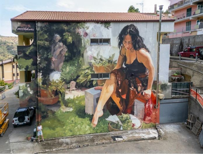 Mural of a seated woman barefoot in a garden, surrounded by plants, potted soil, and household items. The mural is painted in impressionistic, textured strokes.