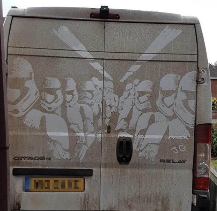 Dirty van mural depicting multiple stormtroopers inside a futuristic train carriage, drawn in symmetrical perspective with light bars overhead by James Gibson.