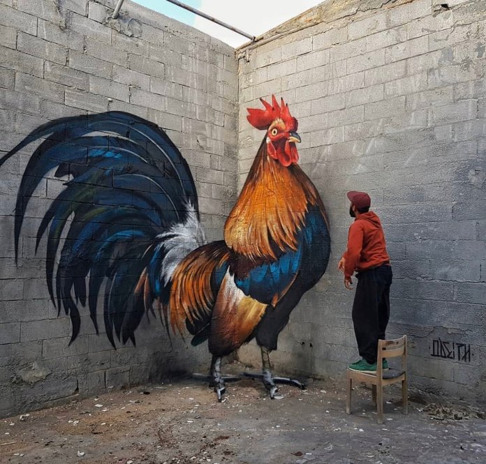 A realistic mural of a giant rooster painted across two adjoining concrete walls and the floor. The artwork is distorted but aligns perfectly from a specific viewing point to appear 3D.