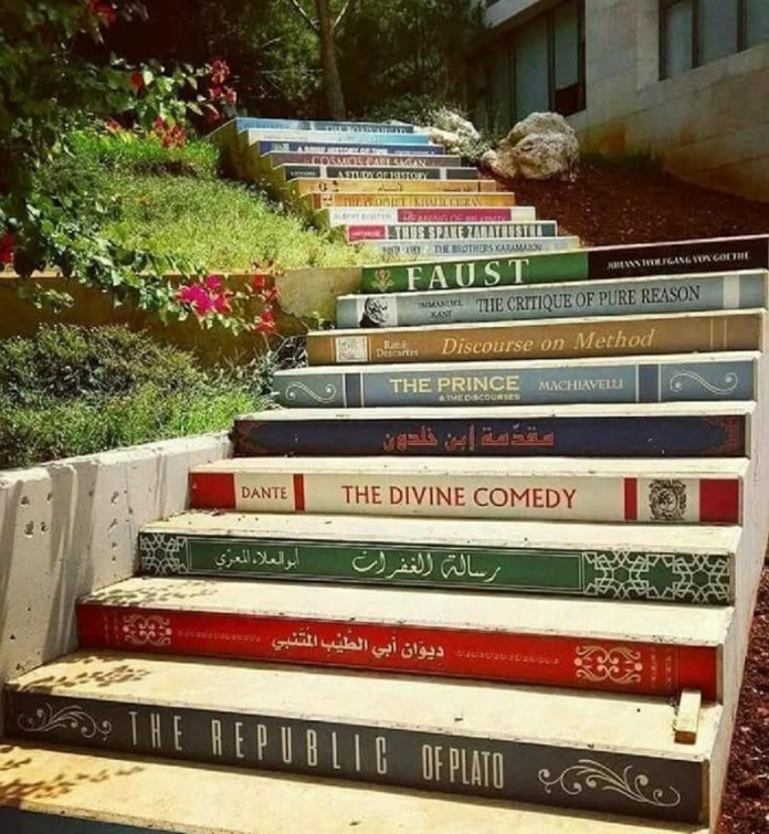 Painted staircase at the University of Balamand in Lebanon, known as the "Stairs of Knowledge," featuring 21 book spines in near-chronological order from classical to modern works, including The Republic of Plato, The Divine Comedy, and Faust. Located beside the university library and surrounded by greenery, the stairs symbolize the ascent through knowledge and education.