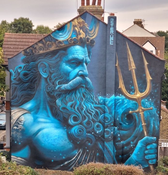 Mural of Poseidon painted in vivid blue tones on a house in London, showing the god holding a golden trident, with swirling waves around him and a golden crown on his head.