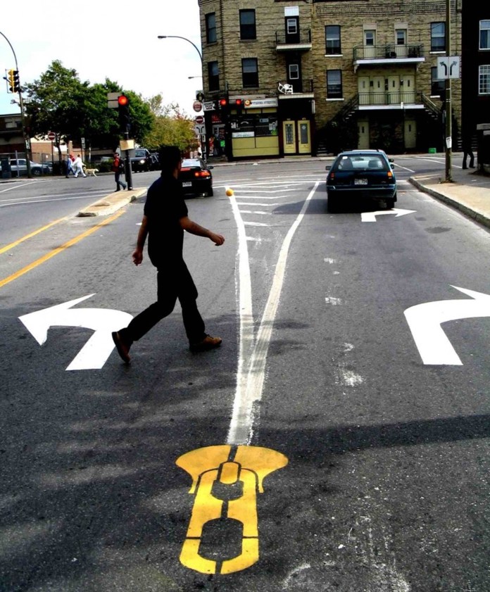 Zipper street art by Roadsworth creatively unzipping a street in Montreal.