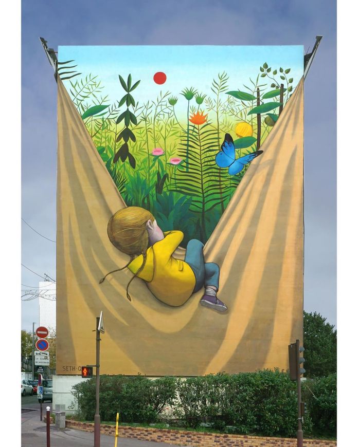 Breathe by Seth in Versailles, France, showing a childlike figure facing into a bright colorful circular mural.