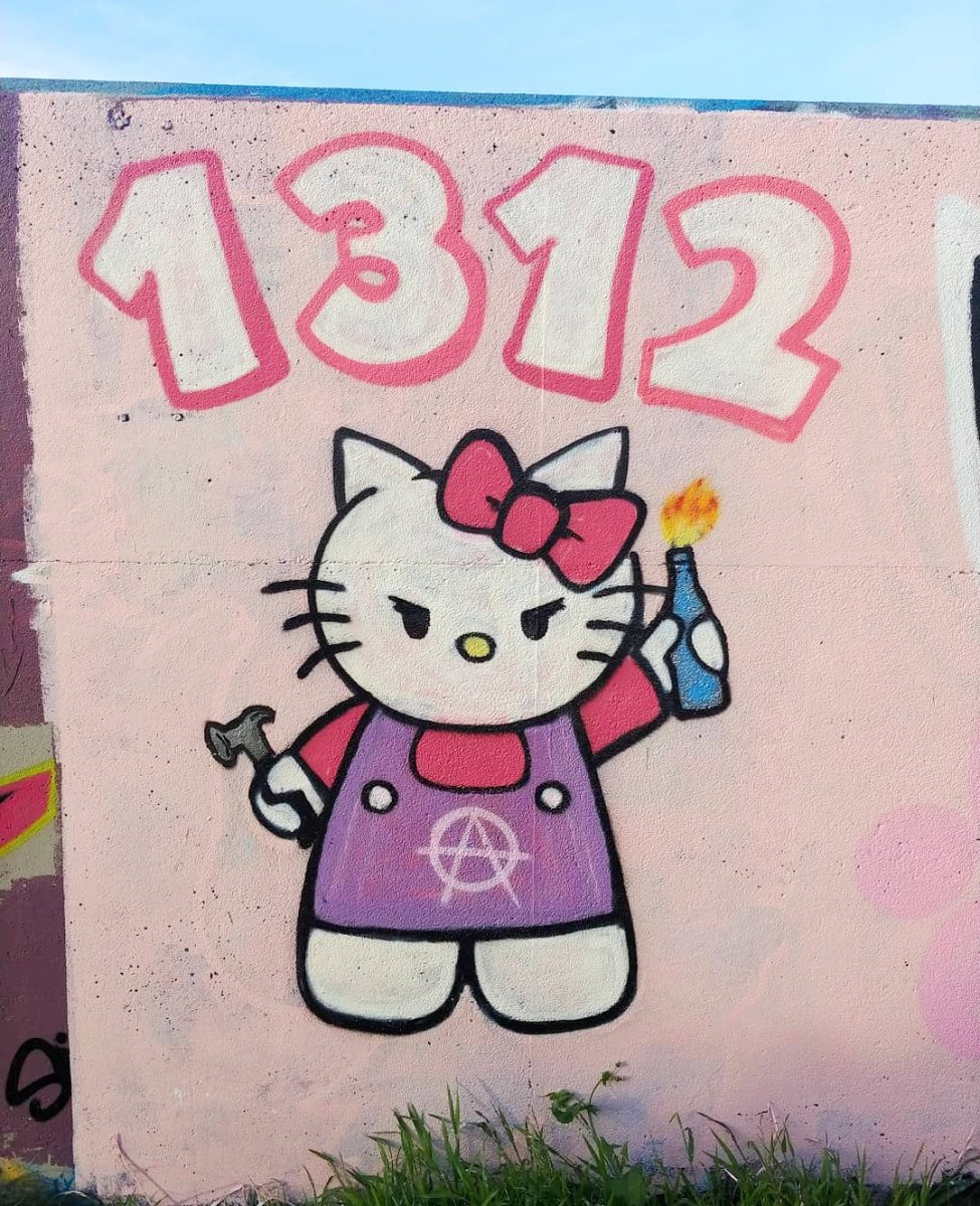 A funny and subversive street art graffiti piece featuring a tough-looking Hello Kitty with the numbers 1312.