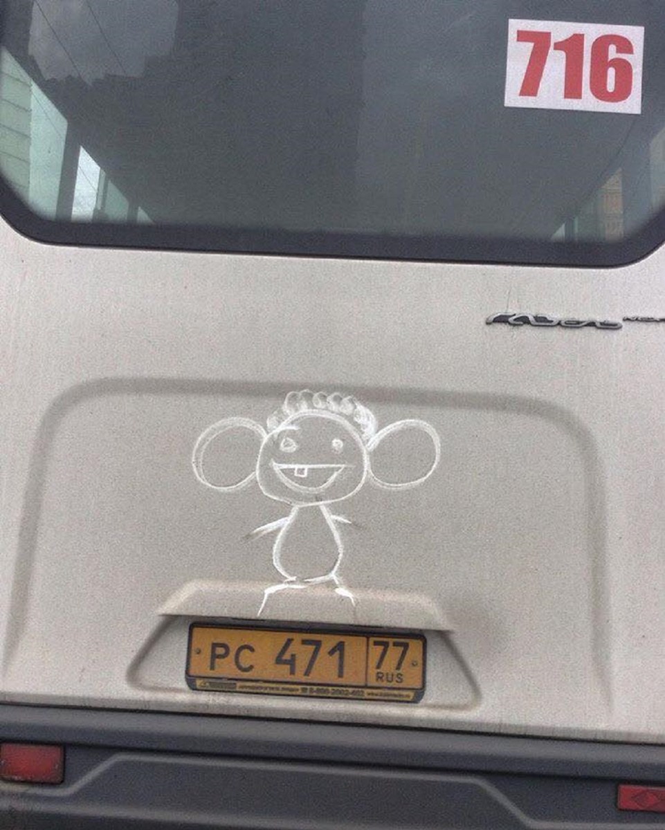 A cute cartoon character with a single tooth drawn in van dust