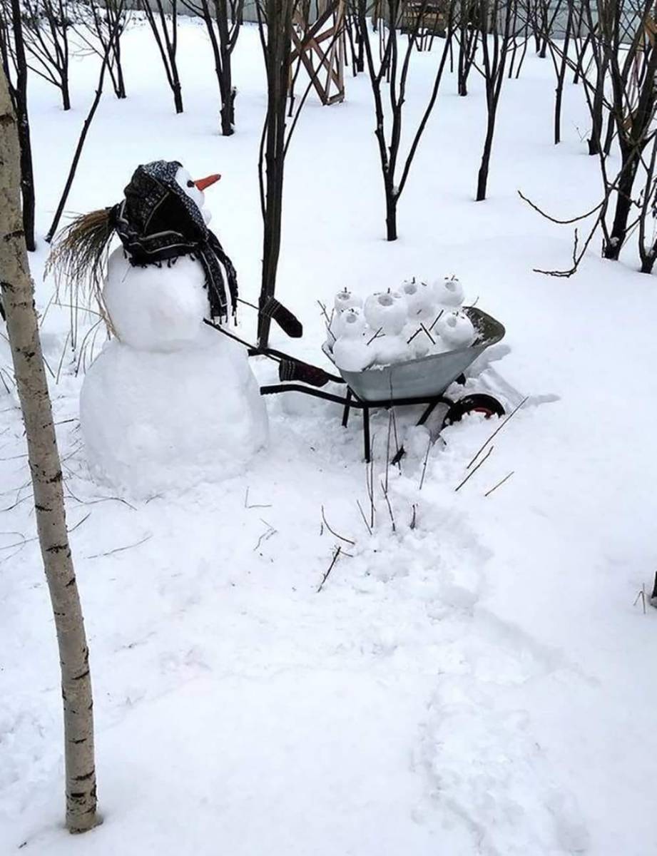Snow woman with wheelbarrow of snow babies