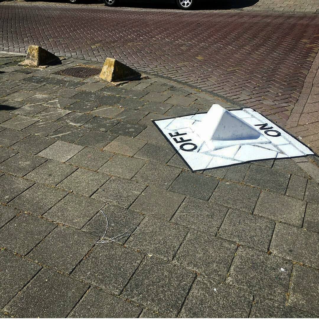 On/Off Switch by Oakoak: a raised sidewalk block painted as a white 3D switch labeled OFF and ON, with the real concrete shape forming the toggle.