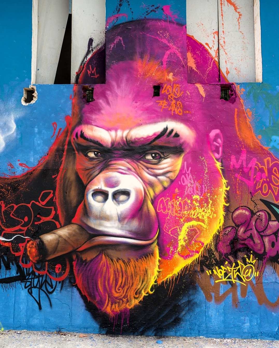 YAOUNDÉ in Full Color by NOE TWO in Itaparica, Brazil, showing a gorilla in bright pink, orange, and purple tones with graffiti details.