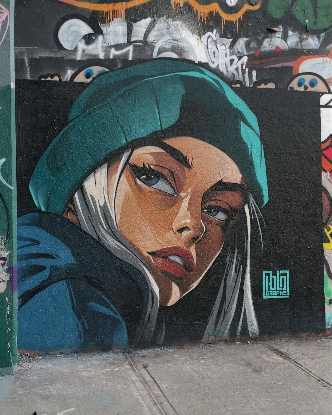 Mural by Polo in Montreal, Canada, showing a close-up of a woman in a teal beanie with long white hair, painted in graphic style with dark outlines and a black background.
