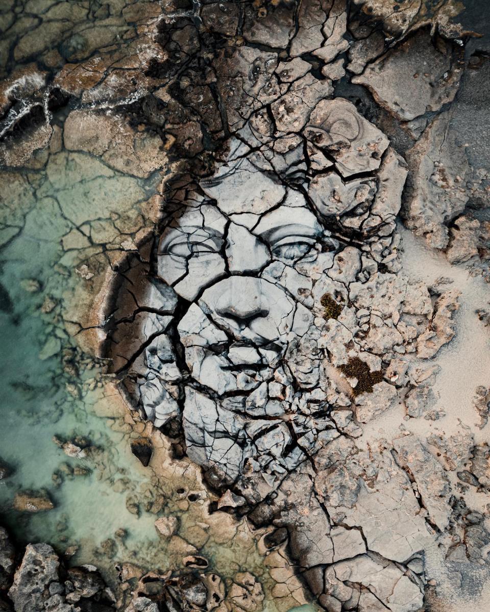 Massive earth fresco land art by David Popa in Crete, Greece, titled Prometheus, painted using naturally sourced pigments on rock.
