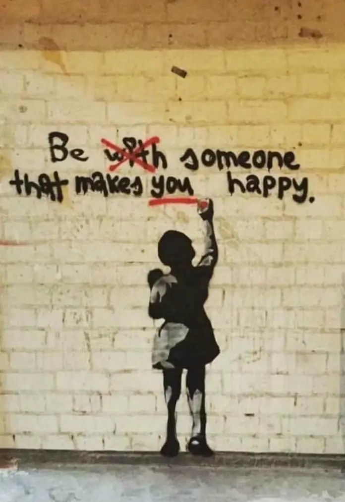 Clever street art intervention in Bristol, UK, where a sentence is edited to read Be Someone That Makes You Happy.