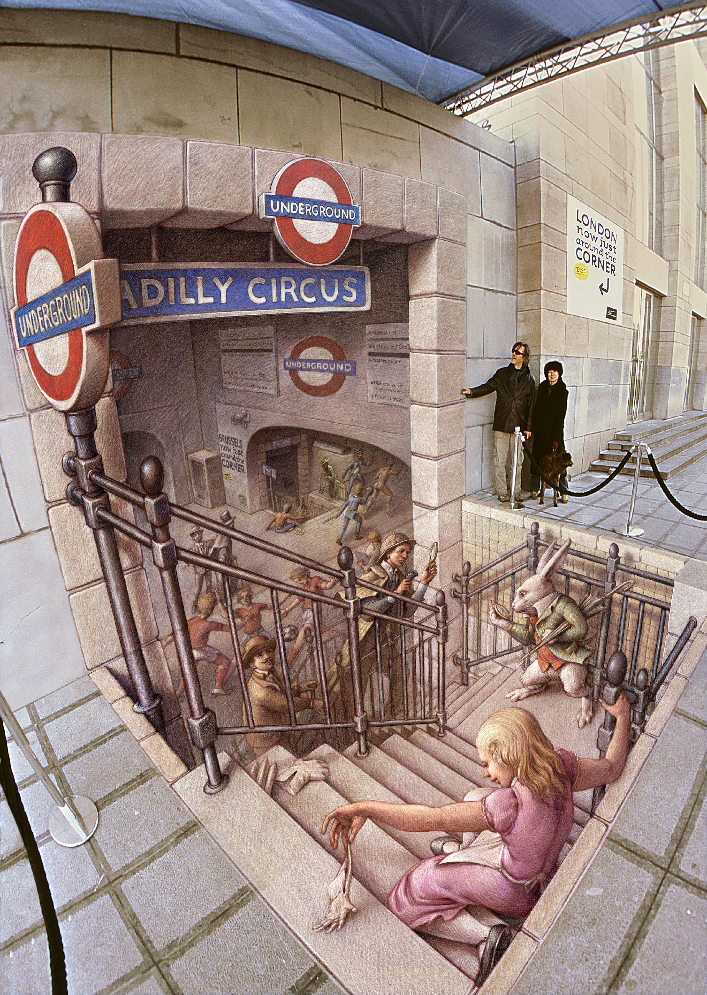 3D chalk drawing on pavement showing a staircase into a surreal version of London’s Underground, with Alice and the White Rabbit descending among a crowd. The illusion creates a deep pit effect with realistic shadows and forced perspective.