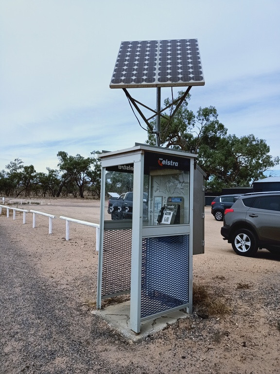 A phone box in the Australian outback with a solar panel on top