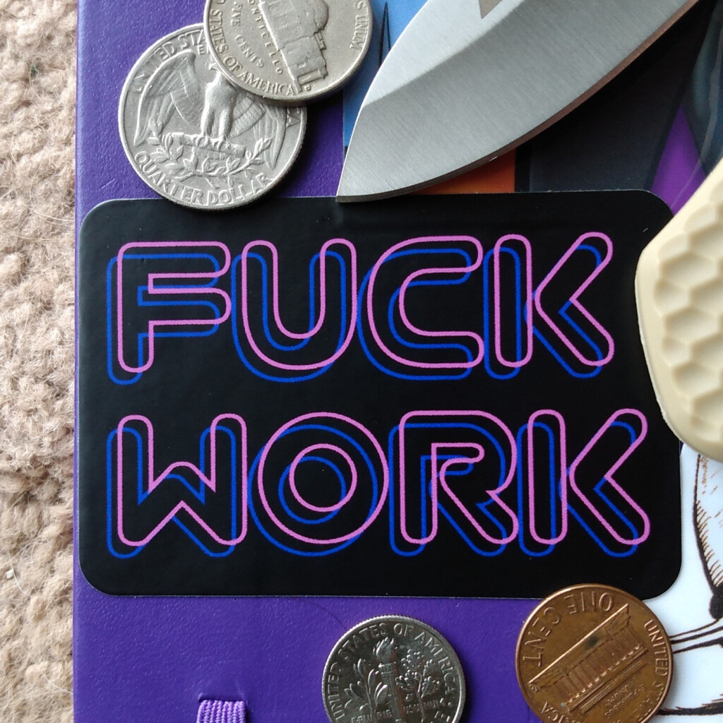 Two by three inch "Fuck Work" vinyl sticker on a notebook with coins and knife for scale.