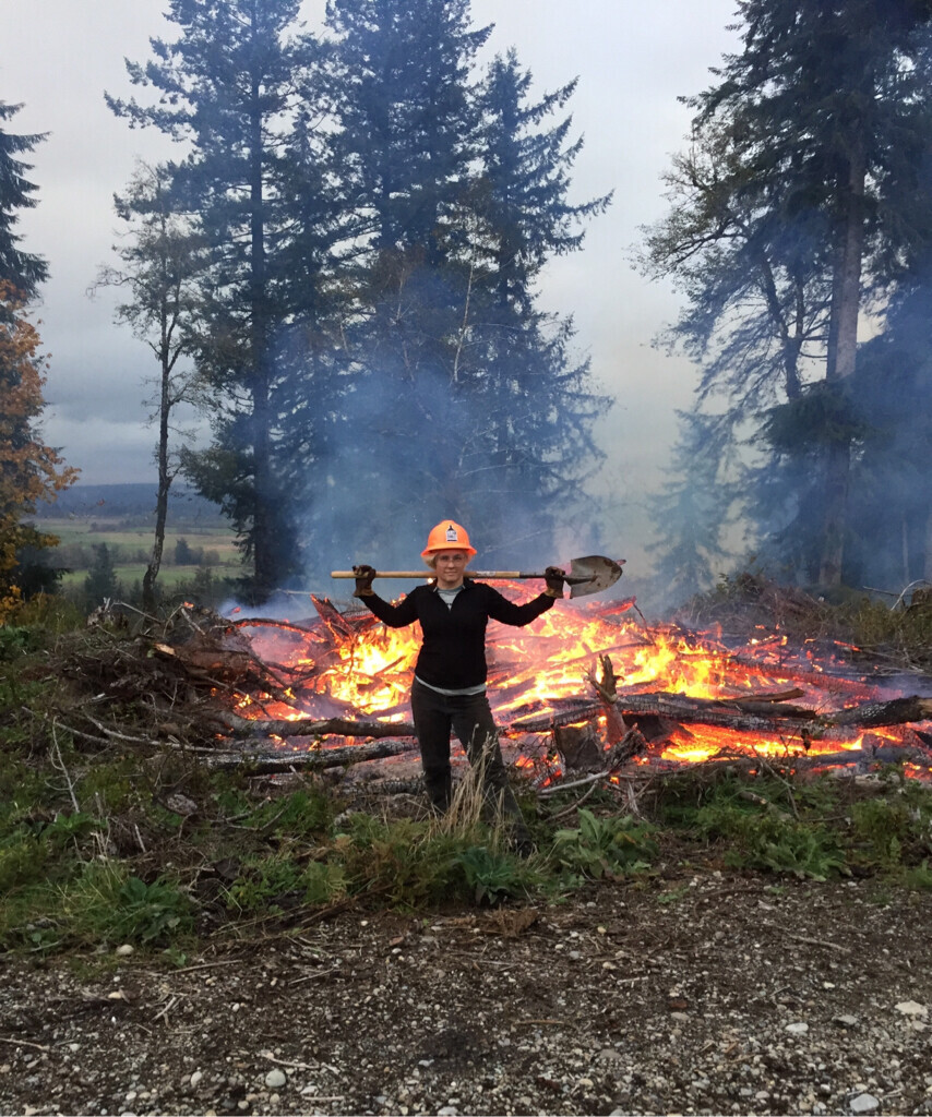 me standing in front of a slag pile fire, holding the shovel over my shoulders