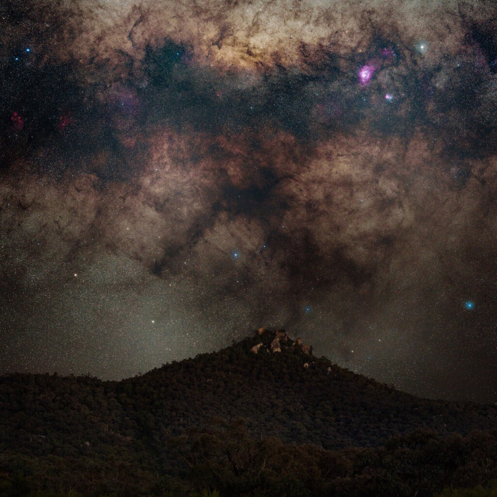 Galactic centre in high resolution descending over Gibraltar Rocks in Tidbinbilla, with prominent lagoon nebula—large, pink, awesome—and war and peace nebula (two duelling nebulae, one pink, one more blue). The galactic centre looks, to my eye at least, like a grumpy cat...
