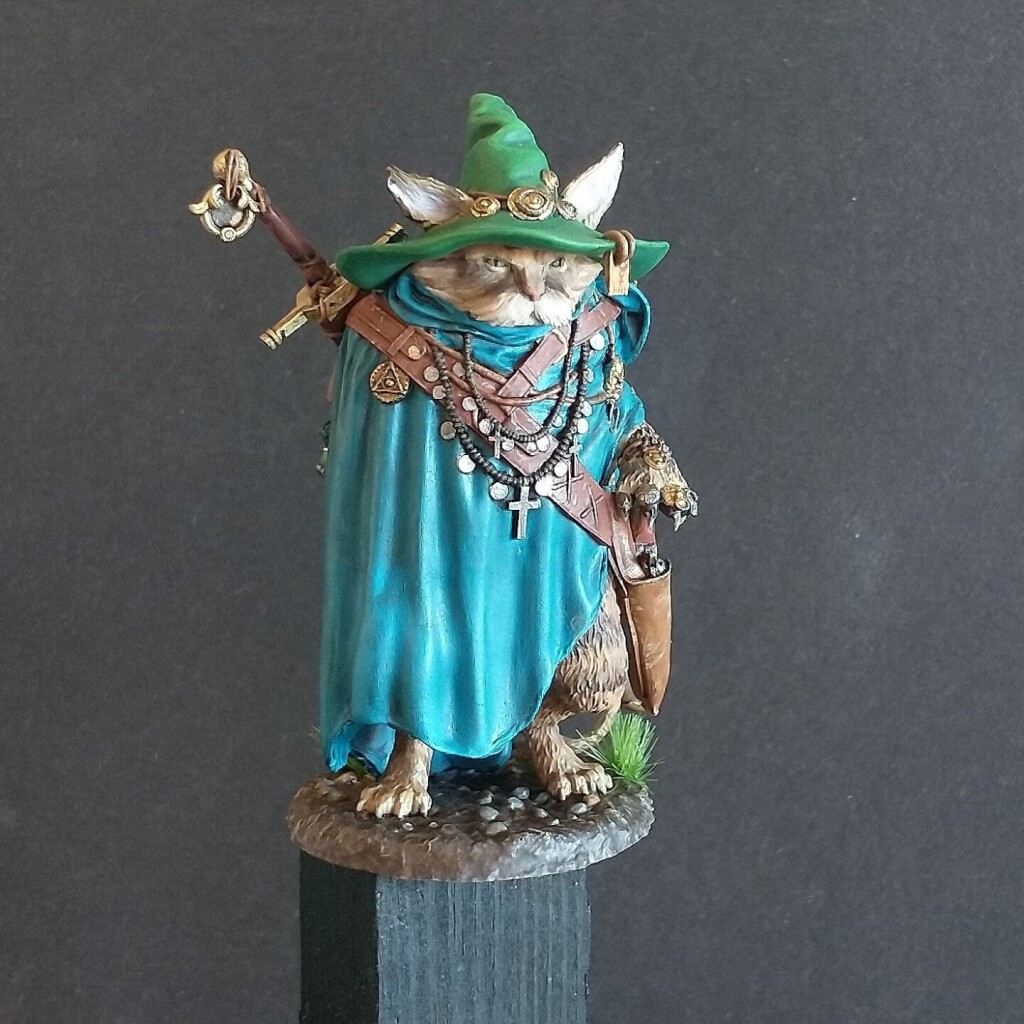 A miniature resin model of a anthropomorphic cat wizard painted with acrylic