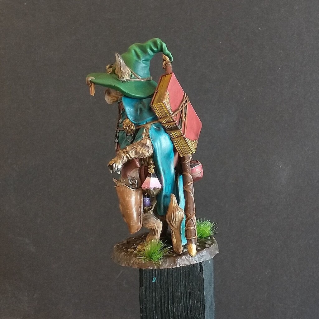 A miniature resin model of a anthropomorphic cat wizard painted with acrylic - side view