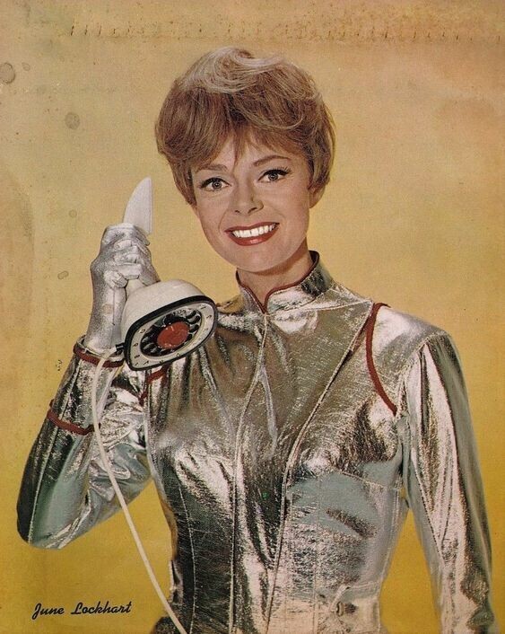 Mrs Robinson wearing a silver space suit and holding a telephone. 
From the TV show Lost in Space