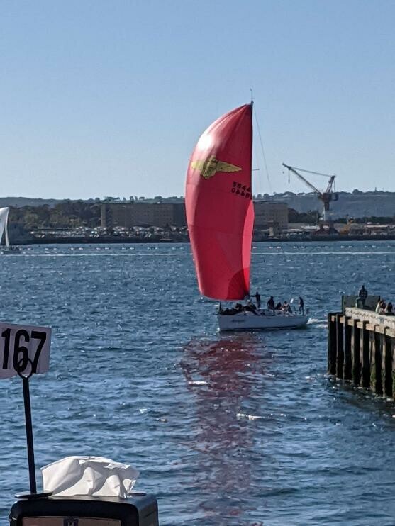 Racing yacht with red sail