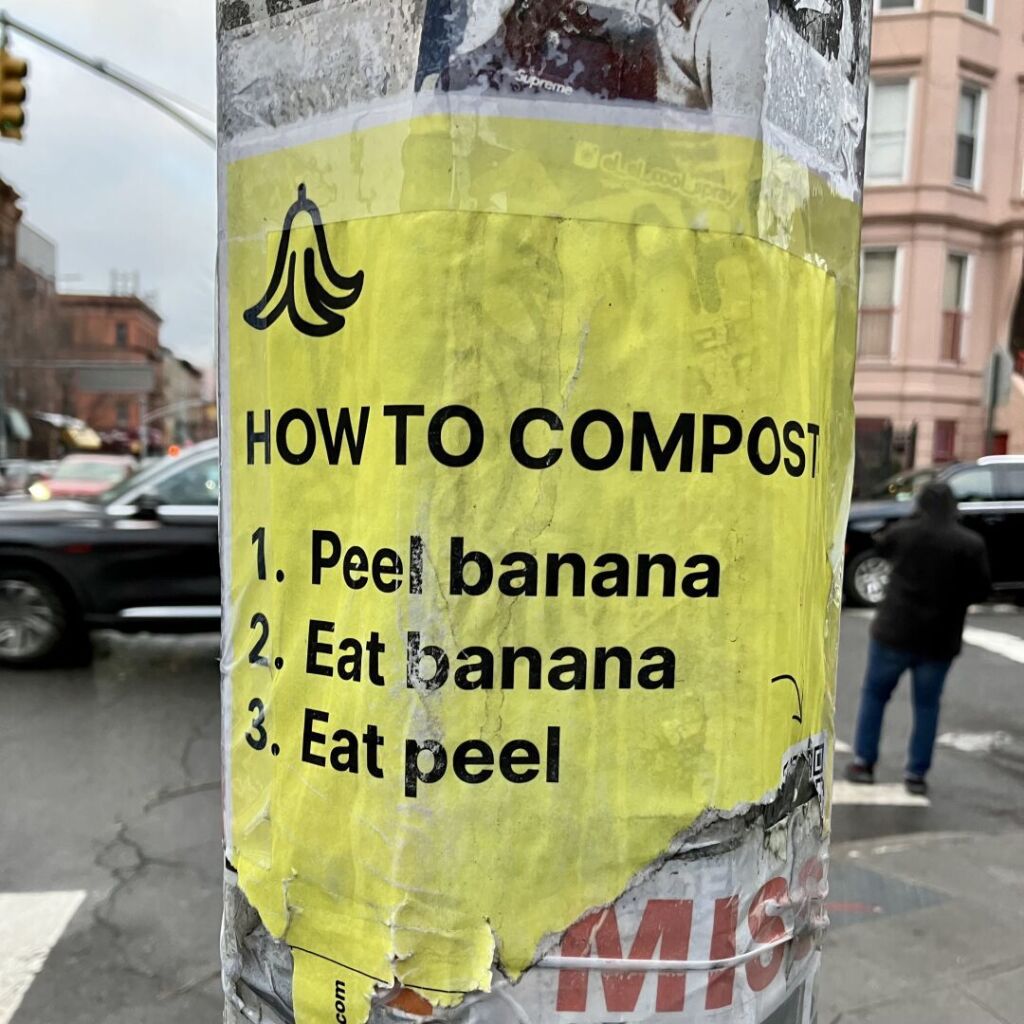 A sign on a lamppost reads:
“How to compost:
1. Peel banana
2. Eat banana
3. Eat peel”