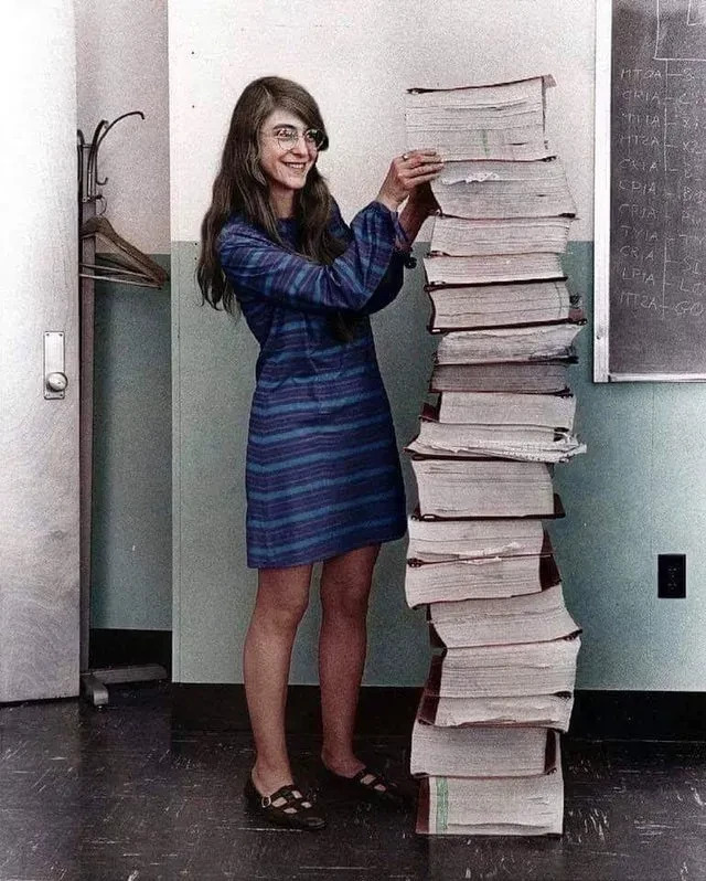 Margaret Hamilton, NASA’s lead developer for the Apollo program, stands next to all the code she wrote by hand that took humanity to the moon in 1969.