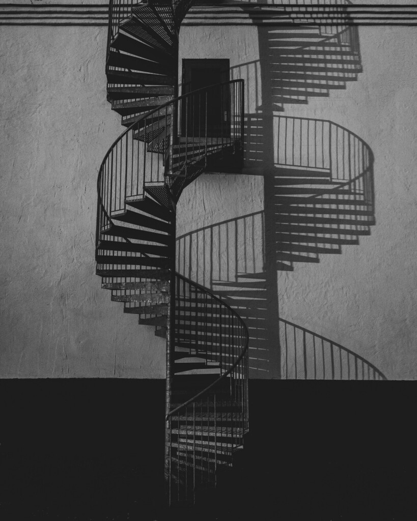 Fire escape casting shadows in the form of a DNA spirale.