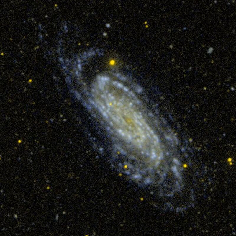 A color photo of galaxy NGC 3198. It is relatively grainy compared to most modern Hubble and JWST images.