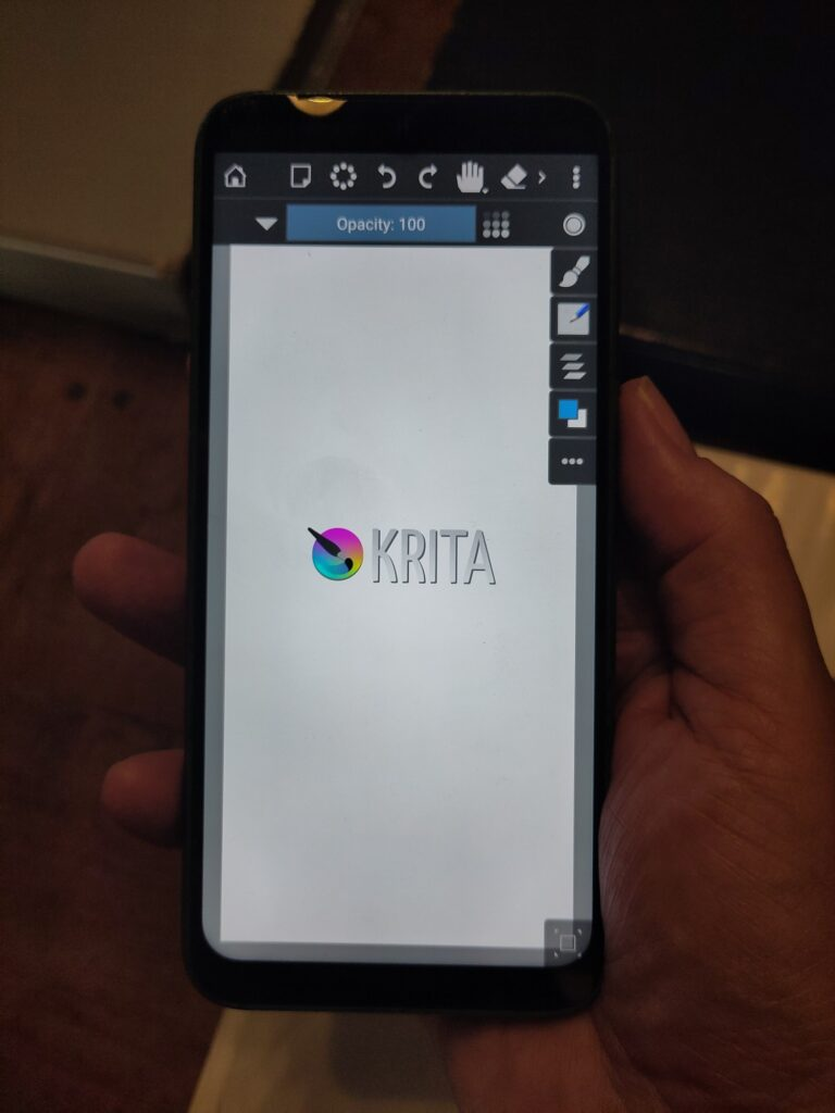 photo of a hand holding a fairphone running the mobile Krita prototype.