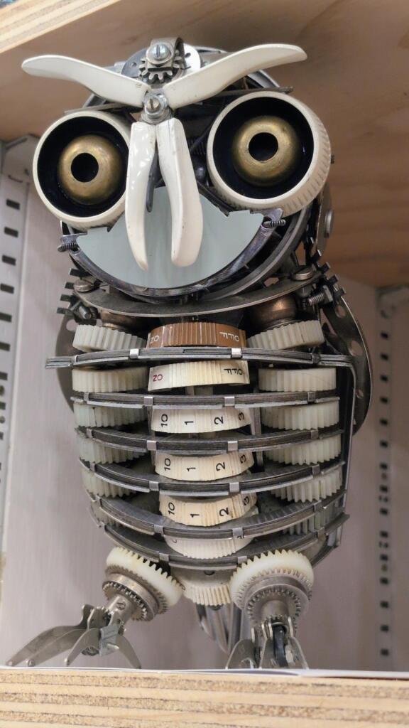 A sculpture of an owl made out of various old typewriter pieces.