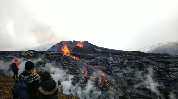 Lava flow from the volcano, seen from quite close. Large cooled-down lava field visible around and in the distance.